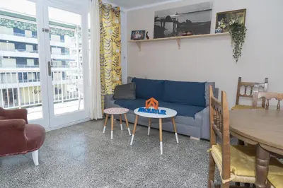 a living room with a blue couch and a table at Saint Germain, A-2-4 in Cullera