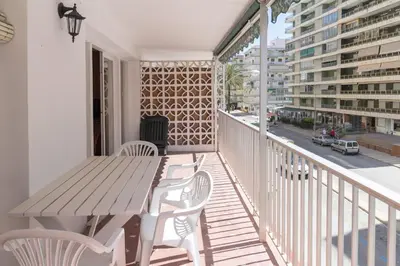a porch with a wooden table and chairs on a balcony at Saint Germain, A-2-4 in Cullera