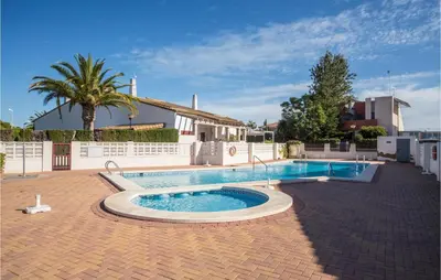 a swimming pool in the middle of a yard at 2 Bedroom Pet Friendly Home In Sagunto in Sagunto