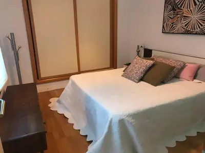 a bedroom with a bed with pillows on it at APARTAMENTO JUNTO AYUNTAMIENTO DE VALENCIA in Valencia