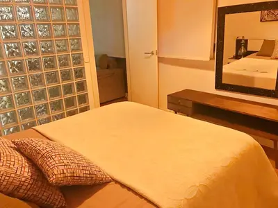 a bedroom with a bed and a large mirror at APARTAMENTO JUNTO AYUNTAMIENTO DE VALENCIA in Valencia
