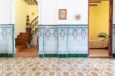 a room with a door with a bed in it at Global Vacacional, Bonita casa rural en Quart de les Valls in Cuart de les Valls