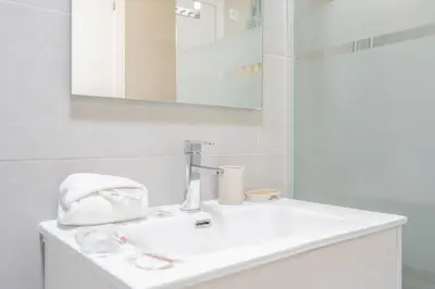 a bathroom with a white sink and a mirror at Apartamento Familiar en Avenida del Puerto in Valencia