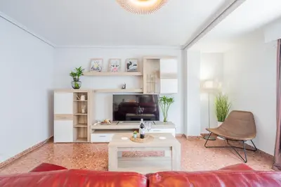 a living room with a couch and a table at Apartamento Familiar en Avenida del Puerto in Valencia