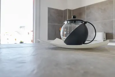 a tea pot sitting on a plate on a table at Town center Apartment El Perello Valencia in El Perelló
