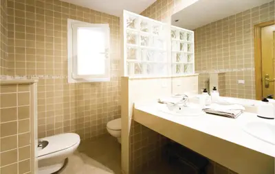 a bathroom with a sink and a toilet at Amazing Home In Riba-Roja De Túria in Riba-Roja De Turia
