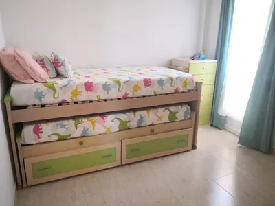 a childs bedroom with a bed and dresser at Espectacular apartment vistas al mar y tranquilidad 10 min desde Valencia in Puebla de Farnals