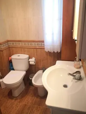 a bathroom with a white toilet and a sink at Espectacular apartment vistas al mar y tranquilidad 10 min desde Valencia in Puebla de Farnals