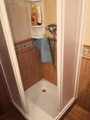 a shower with a shower head in a bathroom at Espectacular apartment vistas al mar y tranquilidad 10 min desde Valencia in Puebla de Farnals