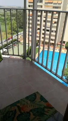 a view of the pool from a balcony of a building at Espectacular apartment vistas al mar y tranquilidad 10 min desde Valencia in Puebla de Farnals