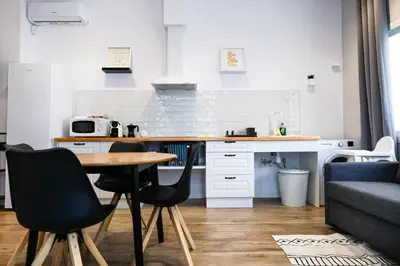 a kitchen with a table and chairs in a room at Playa Apartment in Valencia