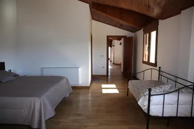a bedroom with two beds and a hallway at Casa Genes Chera in Chera