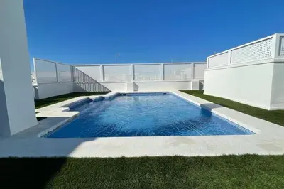 a swimming pool on the side of a building at Precioso apartamento con piscina en Moncofar in Moncófar