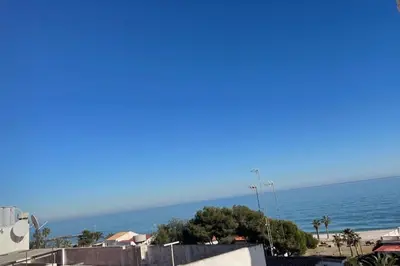 a view of the ocean from a building at Precioso apartamento con piscina en Moncofar in Moncófar