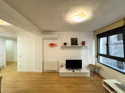 a living room with a flat screen tv on a table at Luxury, design, relax, in historical street lift in Valencia