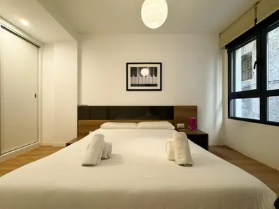 a bedroom with a large white bed with white pillows at Luxury, design, relax, in historical street lift in Valencia