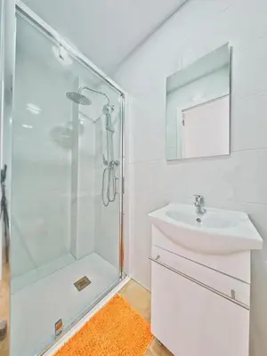 a white bathroom with a sink and a shower at CASA EN LA PLAYA VALENCIA EL PERELLO in Mareny Barraquetas