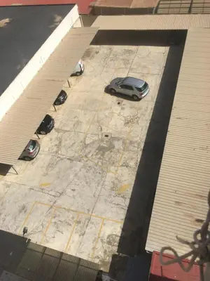 a car parked in a parking lot next to a building at MAGNO CULLERA- Playa in Cullera