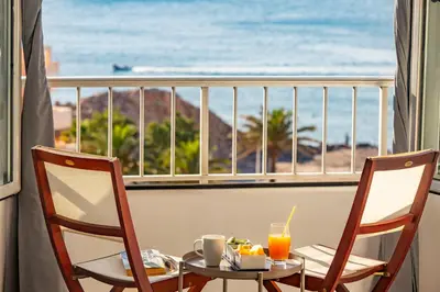a table and chairs with a view of the ocean at Cullera Apartment Faro in Cullera