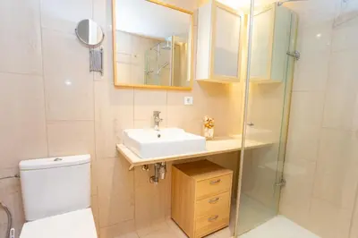 a bathroom with a sink and a toilet and a shower at Cullera Apartment Faro in Cullera