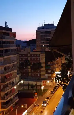 a city street at night with buildings and street lights at Piso familiar con amplia terraza 300m de la playa in Cullera