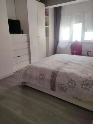 a bedroom with a bed and a dresser and window at Vacansis Pintor Sorolla 2 in Cullera