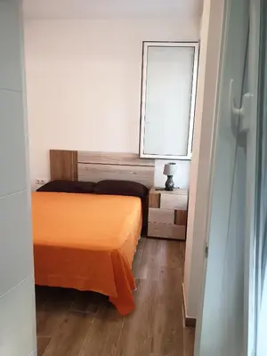 a small room with two beds and a window at Premier Apartments in Valencia