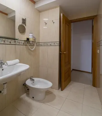 a bathroom with a sink and a toilet and a mirror at Mercat Silence in Valencia
