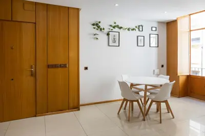 a dining room with a table and white chairs at Mercat Silence in Valencia