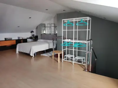 a bedroom with a bed and a white shelving unit at CA PEPICA in Anna