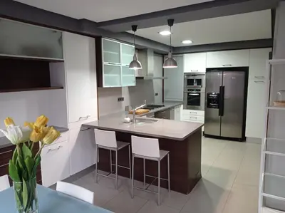 a kitchen with a large island with bar stools at CA PEPICA in Anna