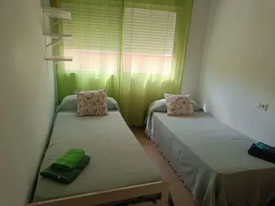 two beds in a room with a window at Apartamento Casa Camacho in Burriana