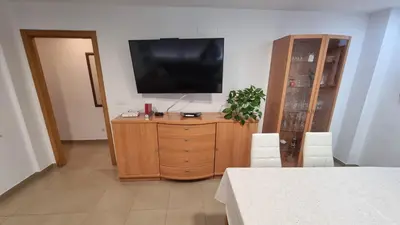 a living room with a television on a wooden dresser at Apartamento Casa Camacho in Burriana
