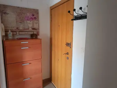 a closet with a wooden door next to a dresser at Apartamento Casa Camacho in Burriana