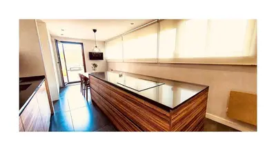 a kitchen with a glass counter top in a room at Lovely penthouse condo with pool in Valencia