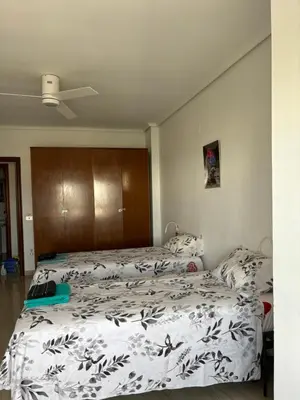 a bedroom with two beds with white and black sheets at CA LAU in Burriana
