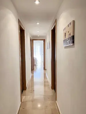 a hallway with white walls and a tile floor at Majestic Flats in Valencia