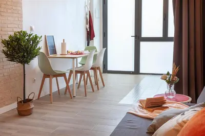 a living room with a dining room table and chairs at NB - Cozy loft steps from City of Arts & Sciences in Valencia