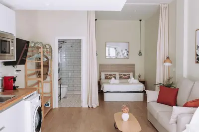 a small living room with a bed and a kitchen at Estelles D Apartment Close To Beach in Valencia