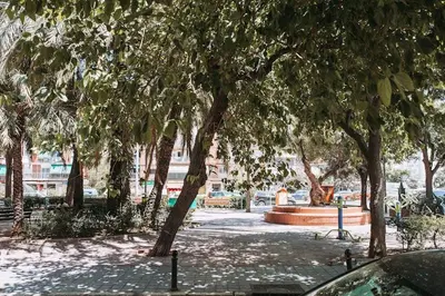 a park with a bunch of trees and a fountain at Estelles D Apartment Close To Beach in Valencia