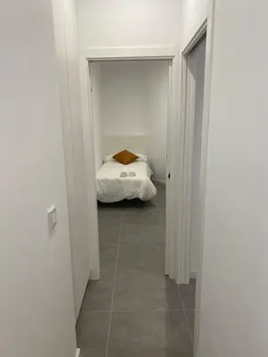 a hallway with a bed in a white room at Cantalar White in Anna