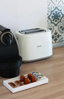 a toaster and a plate of donuts on a counter at Lowenva beach apartment in Canet de Berenguer