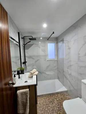a bathroom with a shower and a toilet and a sink at UIM Mediterraneo Isabel 23 Wifi in Puerto de Sagunto
