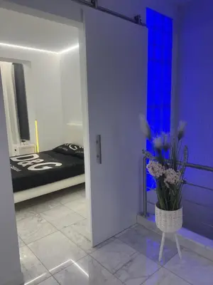 a room with a bed and a vase of flowers at DeLuxe House Valencia in Valencia