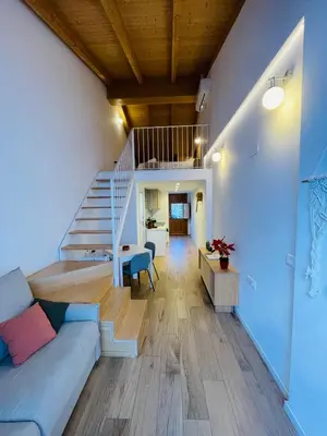 a living room with a couch and a staircase at Casa Valenciana con Terraza in Valencia