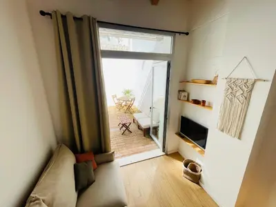 a living room with a couch and a sliding glass door at Casa Valenciana con Terraza in Valencia