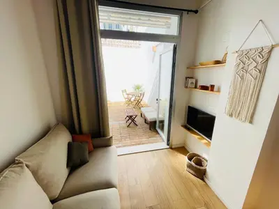 a living room with a couch and a sliding glass door at Casa Valenciana con Terraza in Valencia