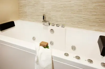 a bathroom with a bath tub with a towel on it at Torre Buen Aire cerca de Valencia, con jacuzzi y barbacoa in Benafer