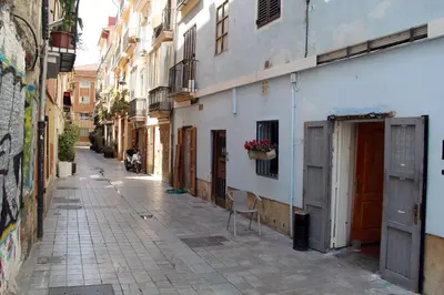an empty alley with a chair in a building at City Centre Room in Valencia