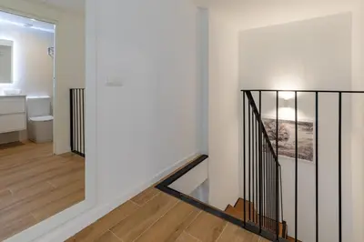 a staircase in a house with a bathroom at Travel Habitat Alameda Suites. in Valencia